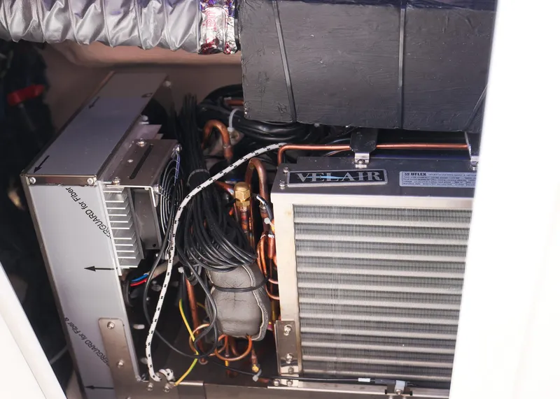 Slide: The Image of 2025 Blackwater 43 Sportfish engine compartment with visible wiring and cooling system components. - 48