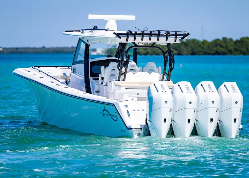Slide: The Image of 2025 Blackwater 43 Sportfish boat with four engines on turquoise water. - 5