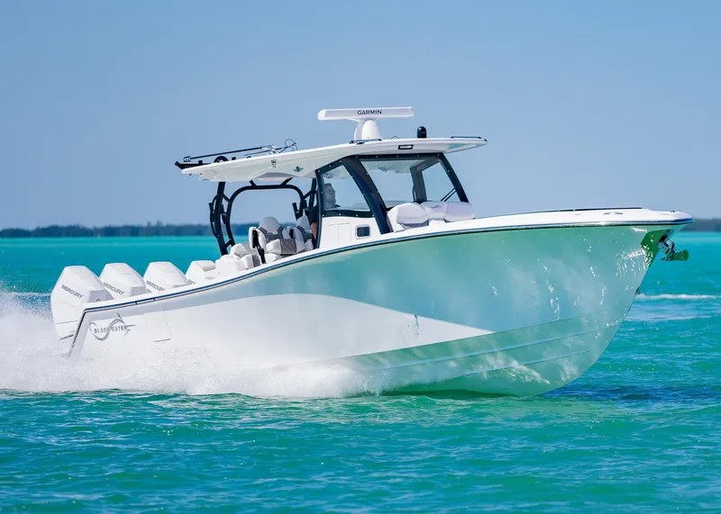 Slide: The Image of 2025 Blackwater 43 Sportfish boat cruising on clear blue water. - 6
