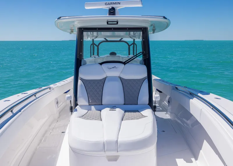 Slide: The Image of 2025 Blackwater 43 Sportfish boat on turquoise water, featuring sleek seating and Garmin equipment. - 9