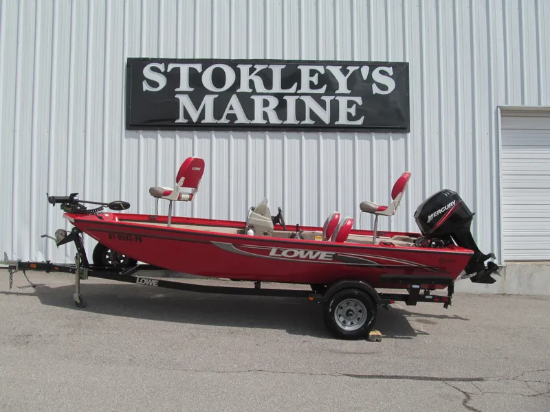 Slide: The Image of 2006 Lowe Stinger 160 boat at Stokley's Marine, featuring red design and Mercury engine. - 1