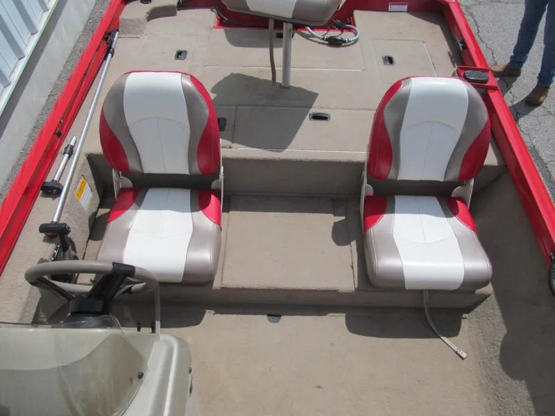 Slide: The Image of 2006 Lowe Stinger 160 boat interior with red and white seats, steering wheel visible. - 11