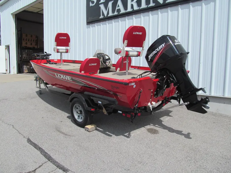 Slide: The Image of 2006 Lowe Stinger 160 boat with Mercury 50HP engine, red color, parked outside a marine shop. - 3