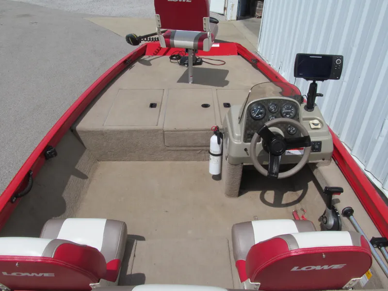 Slide: The Image of 2006 Lowe Stinger 160 boat interior with steering console and seating. - 5