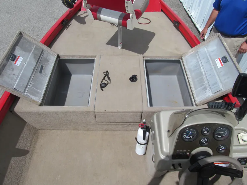 Slide: The Image of 2006 Lowe Stinger 160 boat interior with open storage compartments and control panel. - 8