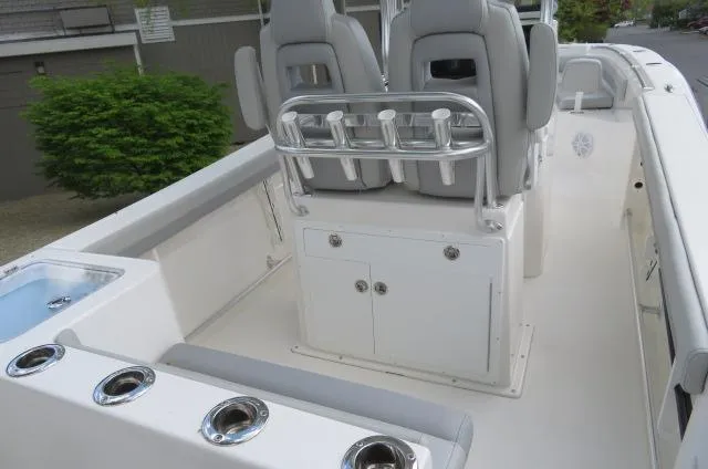 Slide: The Image of 2025 KenCraft 25 Offshore boat interior with seating and rod holders. - 10