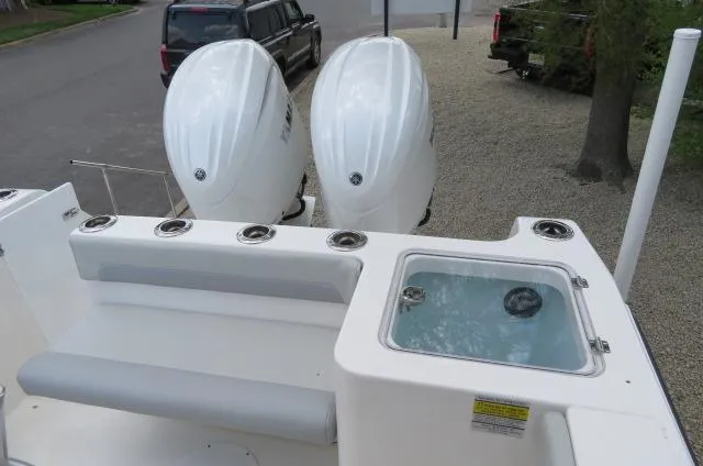 Slide: The Image of 2025 KenCraft 25 Offshore boat with dual outboard engines and a livewell on deck. - 12