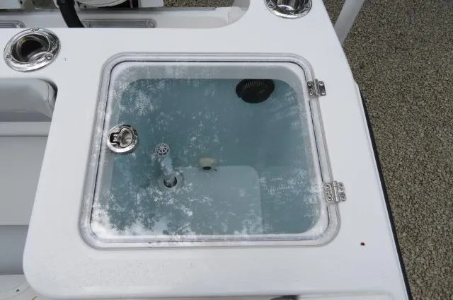 Slide: The Image of Livewell on 2025 KenCraft 25 Offshore boat, featuring a clear lid and stainless steel fittings. - 13