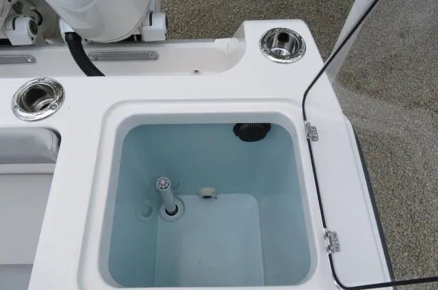 Slide: The Image of Livewell on 2025 KenCraft 25 Offshore boat, featuring cup holders and open lid. - 14