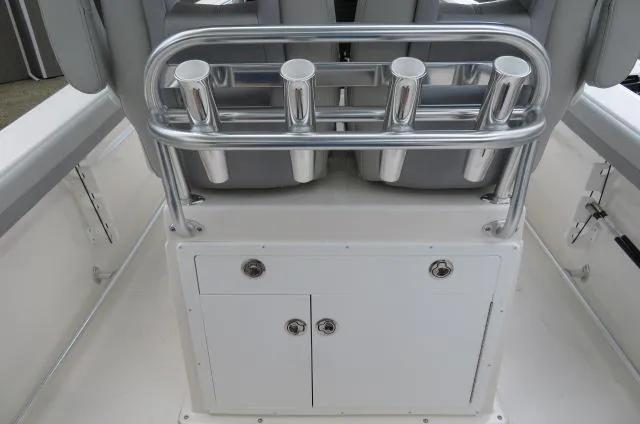 Slide: The Image of 2025 KenCraft 25 Offshore boat console with rod holders and storage compartments. - 18