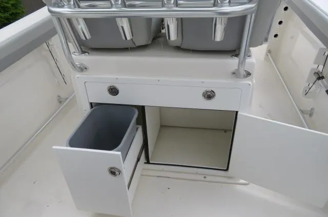 Slide: The Image of KenCraft 25 Offshore 2025 boat storage compartments with open doors and bins. - 21