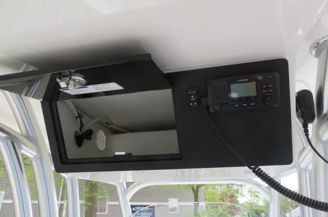 Slide: The Image of 2025 KenCraft 25 Offshore boat interior with radio and storage compartment. - 23