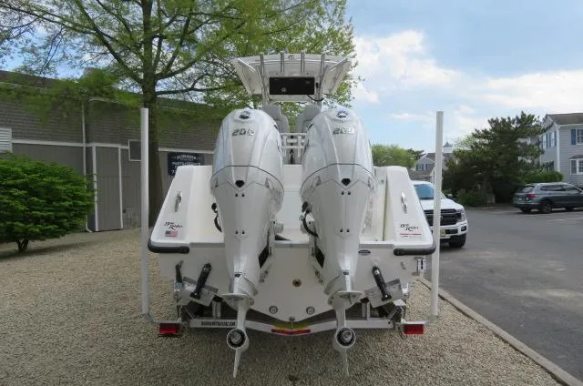 Slide: The Image of 2025 KenCraft 25 Offshore boat with dual outboard engines, parked on gravel driveway. - 3