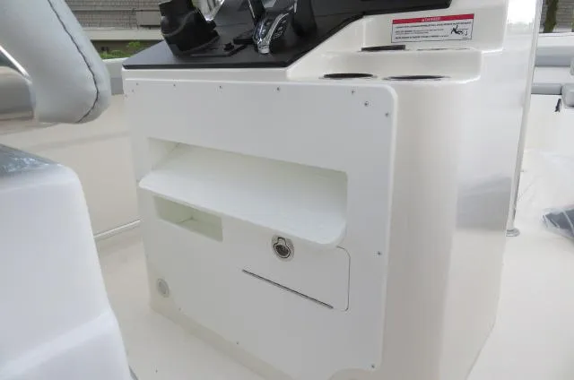 Slide: The Image of 2025 KenCraft 25 Offshore boat console with storage compartments and controls. - 32