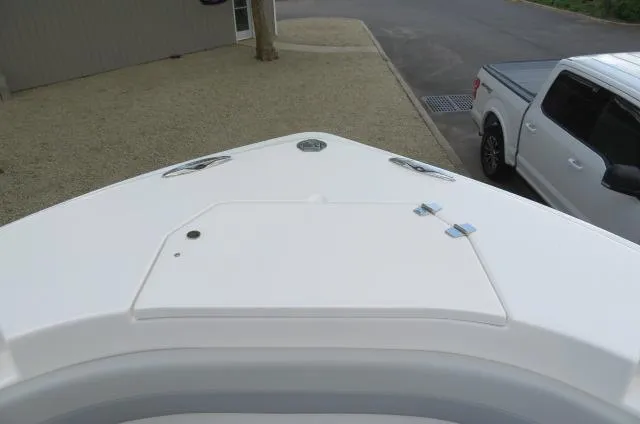 Slide: The Image of 2025 KenCraft 25 Offshore boat bow view with white truck nearby. - 35