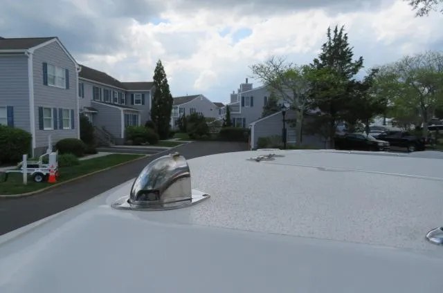 Slide: The Image of KenCraft 25 Offshore 2025 boat detail with residential neighborhood in background. - 36