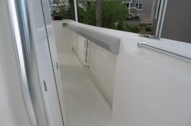 Slide: The Image of 2025 KenCraft 25 Offshore boat deck with railing and cushioned side panel. - 44