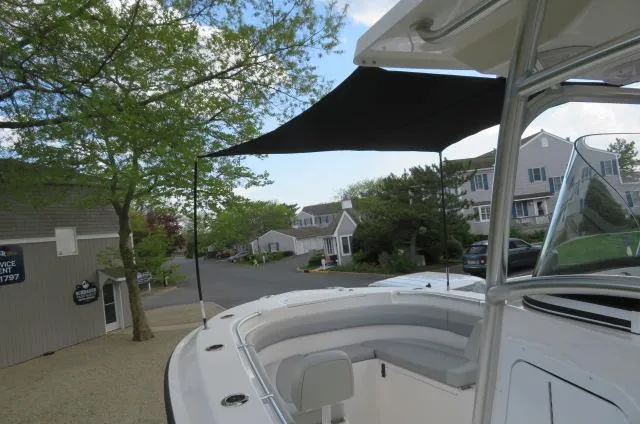 Slide: The Image of 2025 KenCraft 25 Offshore boat with canopy, parked in a residential area. - 49