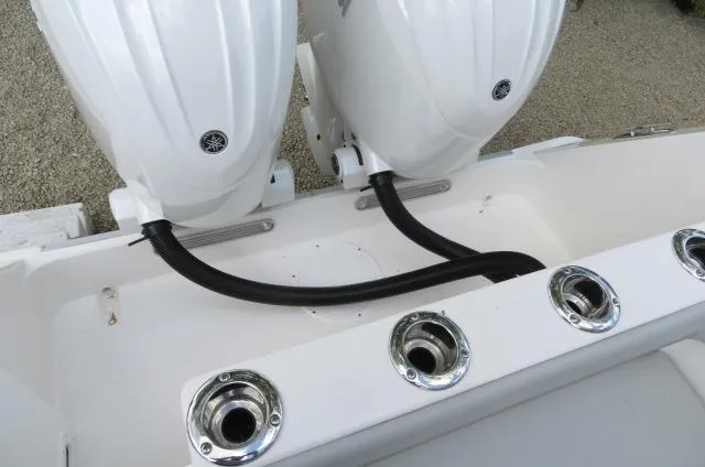 Slide: The Image of 2025 KenCraft 25 Offshore boat with dual outboard motors and rod holders. - 6