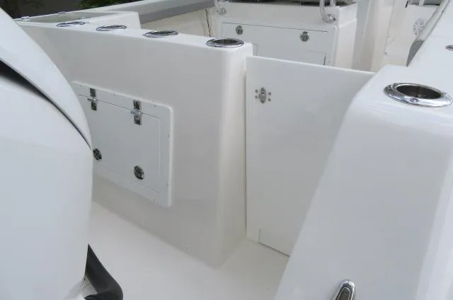 Slide: The Image of 2025 KenCraft 25 Offshore boat interior with storage compartments and rod holders. - 8