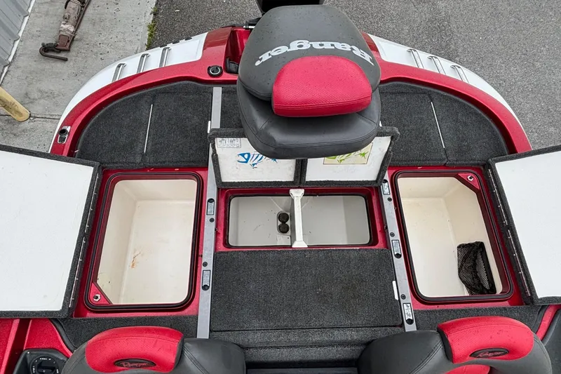 Slide: The Image of 2005 Ranger Z20 Comanche boat interior with open storage compartments and red accents. - 10