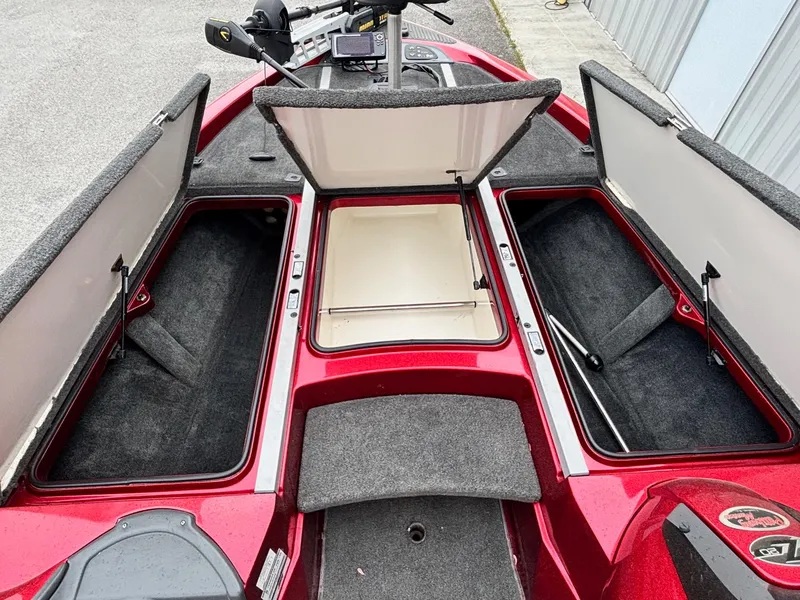 Slide: The Image of 2005 Ranger Z20 Comanche boat with open storage compartments, red exterior, and fishing equipment. - 3