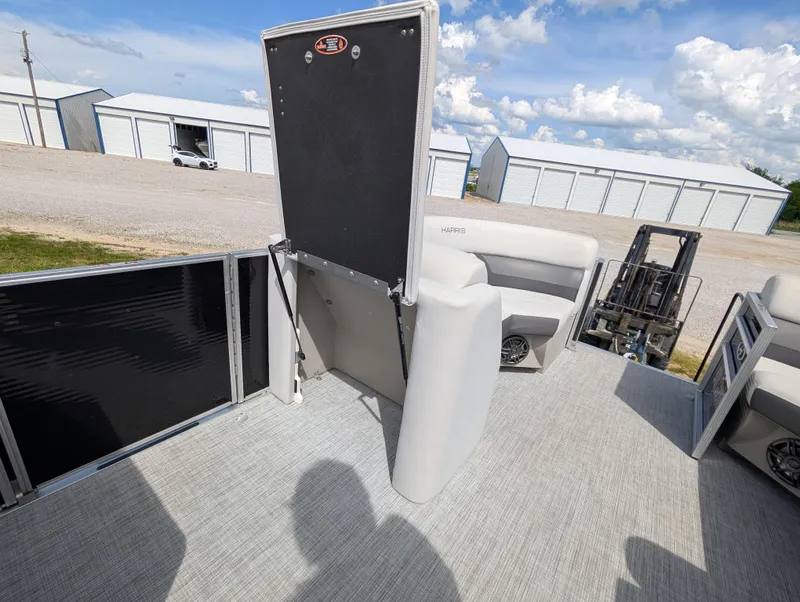 Slide: The Image of 2022 Harris Cruiser 210 pontoon boat interior with seating and storage compartments. - 11