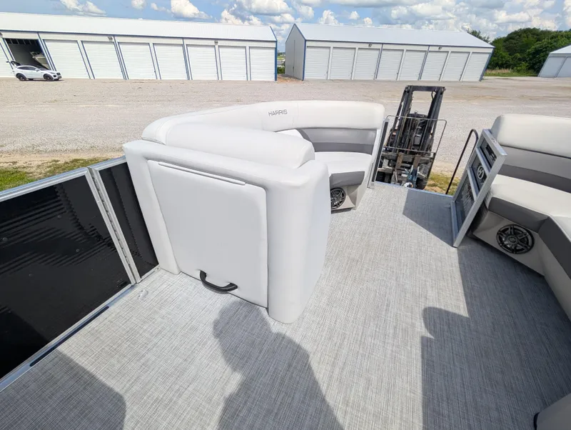 Slide: The Image of 2022 Harris Cruiser 210 pontoon boat interior with gray seating and storage compartments. - 12