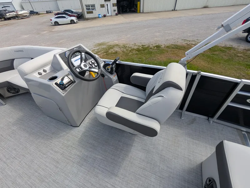 Slide: The Image of 2022 Harris Cruiser 210 boat interior with steering console and captain's chair. - 14