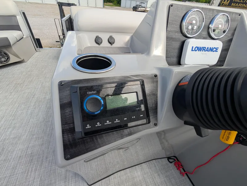 Slide: The Image of Control panel of 2022 Harris Cruiser 210 boat with Lowrance system and cup holder. - 16