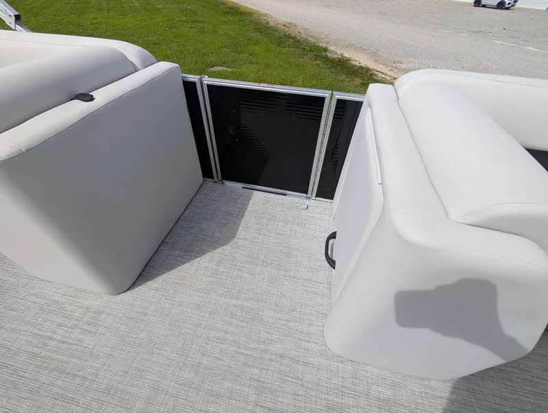 Slide: The Image of 2022 Harris Cruiser 210 boat interior with gray seating and carpeted floor. - 23