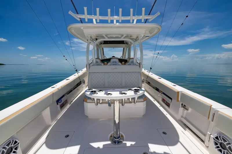 Slide: The Image of 2024 Blackwater 43 Sportfish boat, spacious deck, clear blue sky, calm sea. - 31