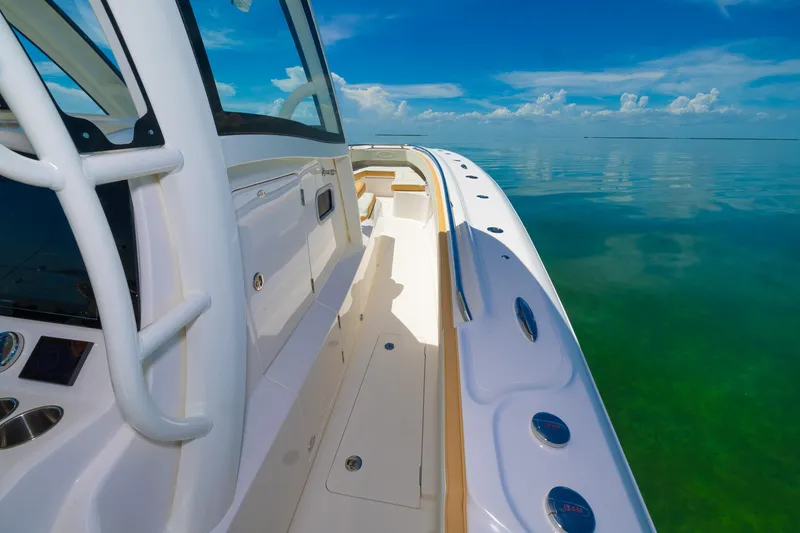Slide: The Image of 2024 Blackwater 43 Sportfish boat on calm, clear waters under a bright blue sky. - 41
