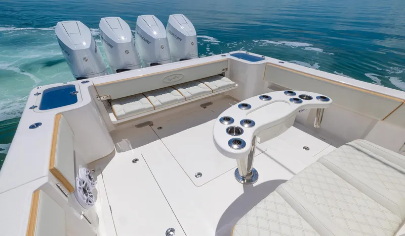 Slide: The Image of 2024 Blackwater 43 Sportfish boat with quad engines, luxurious seating, and rod holders on calm water. - 42