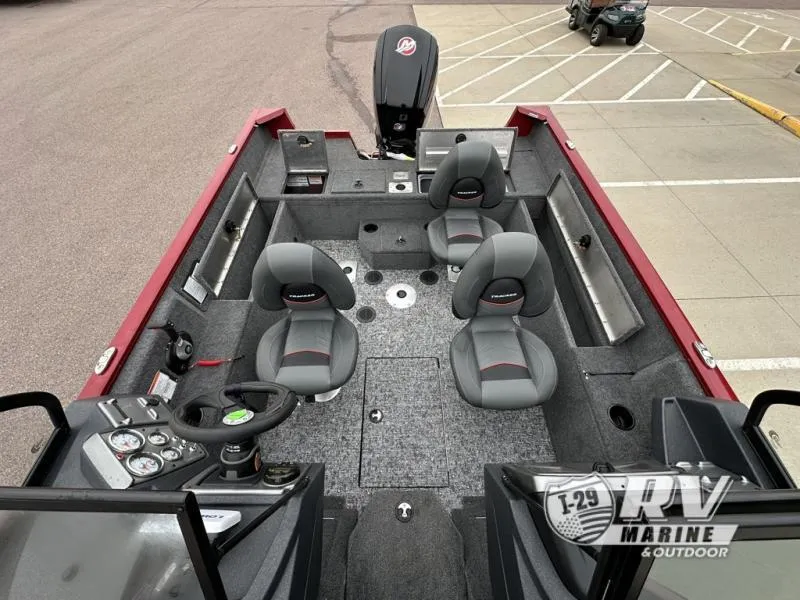Slide: The Image of 2025 Tracker Pro Guide V-175 WT boat interior with seating and control panel, parked in a lot. - 13
