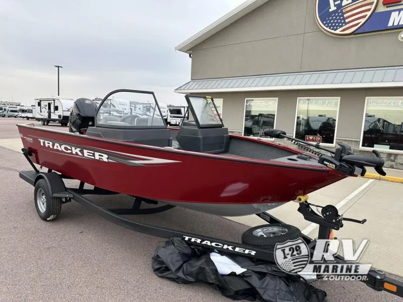 Slide: The Image of 2025 Tracker Pro Guide V-175 WT boat on trailer outside dealership. - 7