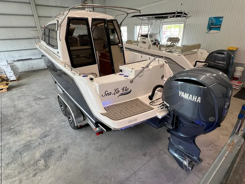 Slide: The Image of 2022 Cutwater C-24 Coupe boat with Yamaha engine in a showroom. - 2
