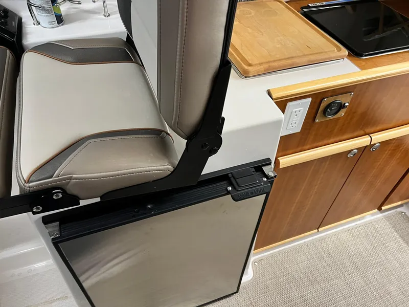 Slide: The Image of Interior of 2022 Cutwater C-24 Coupe featuring seating and kitchenette area. - 23