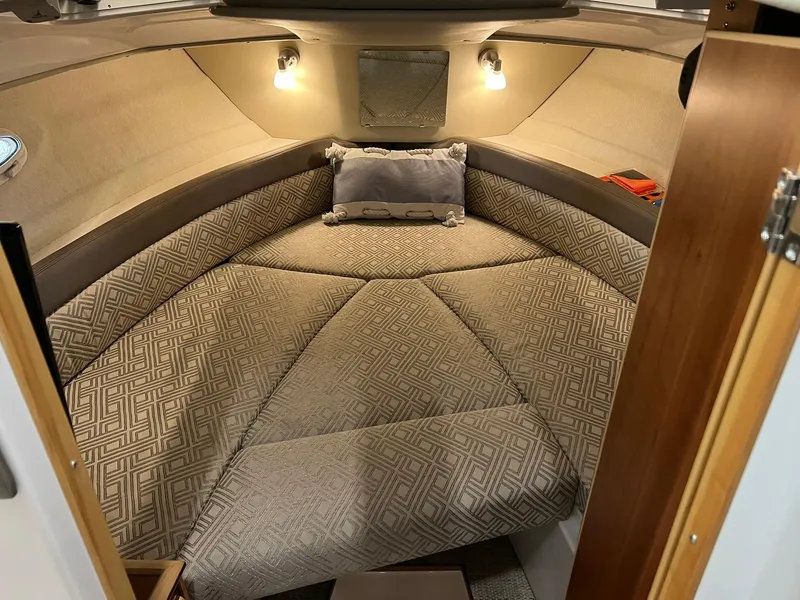 Slide: The Image of 2022 Cutwater C-24 Coupe cabin interior with patterned cushions and ambient lighting. - 27