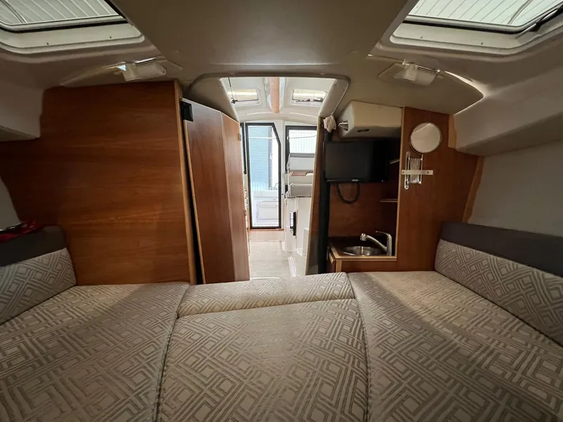 Slide: The Image of Interior of 2022 Cutwater C-24 Coupe boat with cozy seating and compact kitchenette. - 28