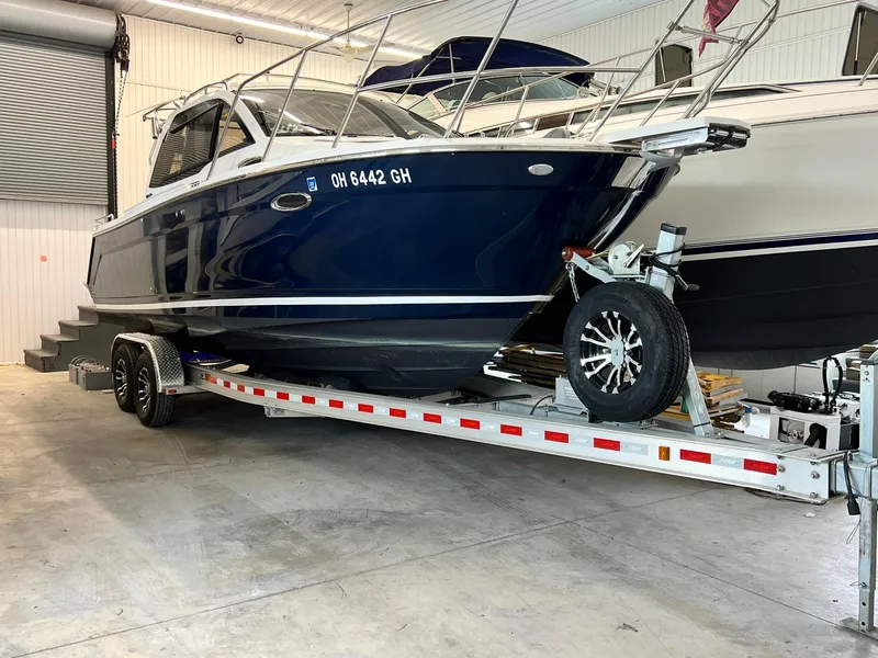 Slide: The Image of 2022 Cutwater C-24 Coupe boat on trailer in indoor storage facility. - 3