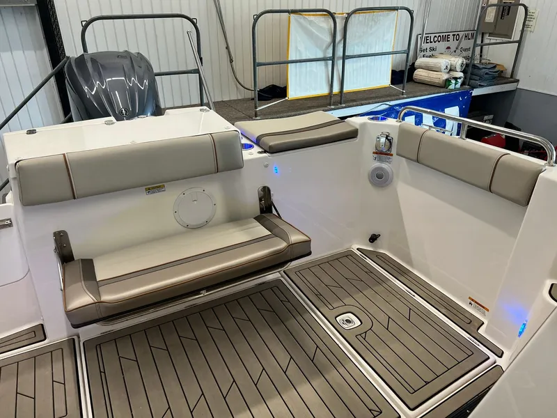 Slide: The Image of 2022 Cutwater C-24 Coupe boat interior with cushioned seating and teak-style flooring. - 32