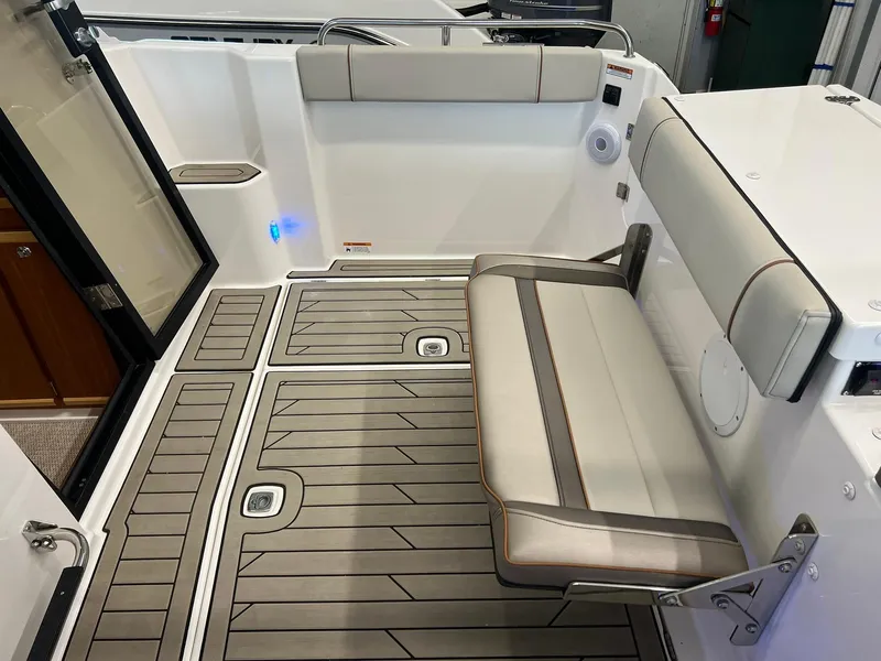 Slide: The Image of 2022 Cutwater C-24 Coupe interior with foldable seating and modern flooring. - 33