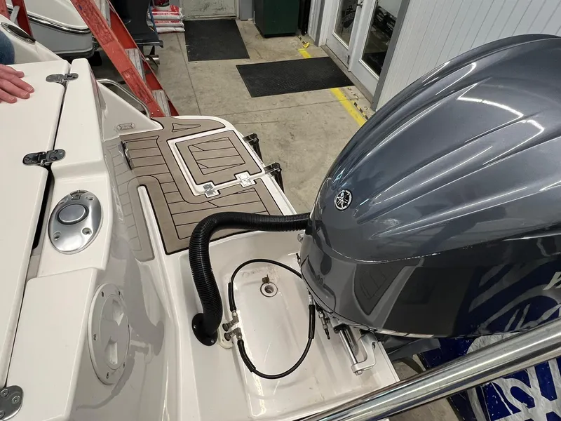 Slide: The Image of 2022 Cutwater C-24 Coupe boat with outboard motor in a showroom setting. - 35