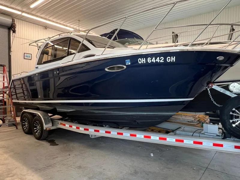 Slide: The Image of 2022 Cutwater C-24 Coupe boat on trailer in indoor storage. - 37