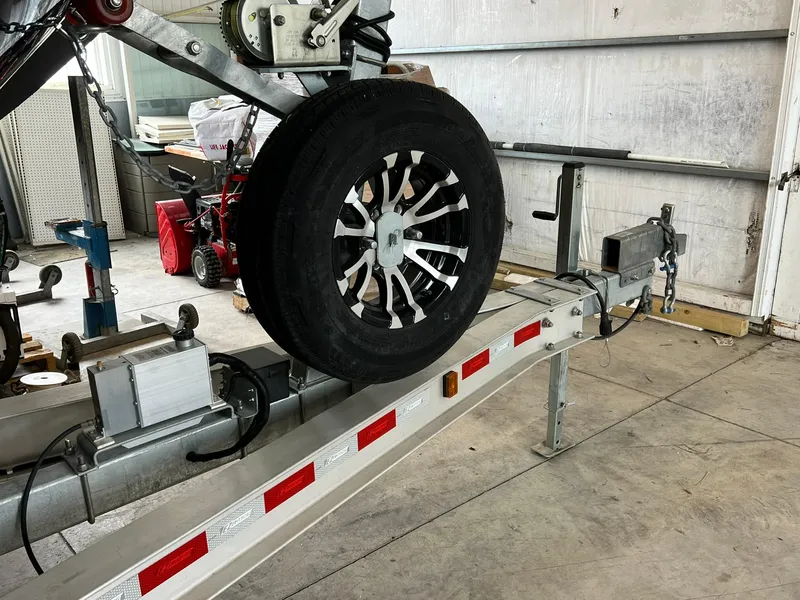 Slide: The Image of Trailer with spare tire for 2022 Cutwater C-24 Coupe in a garage setting. - 39
