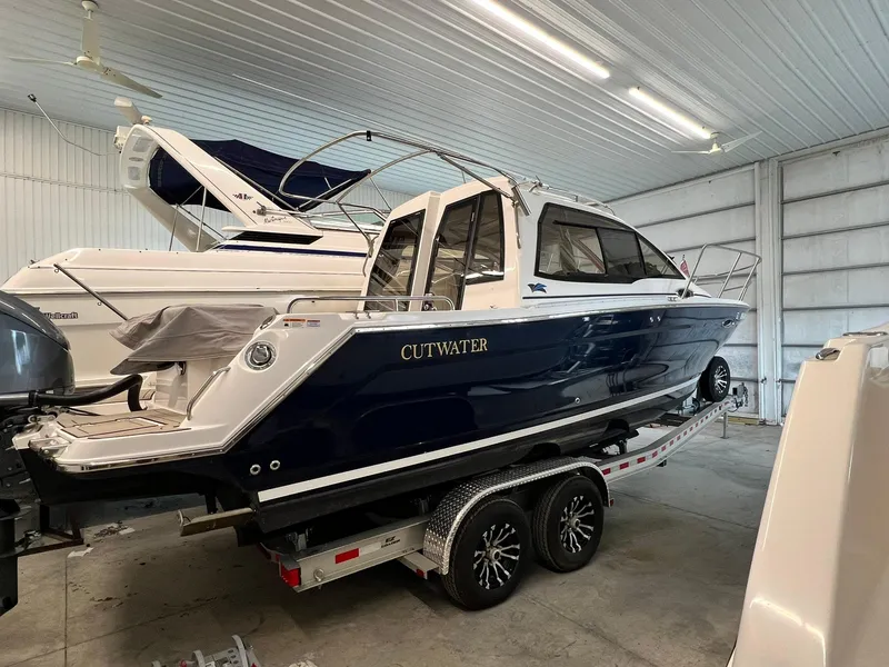 Slide: The Image of 2022 Cutwater C-24 Coupe boat on trailer in indoor storage facility. - 4