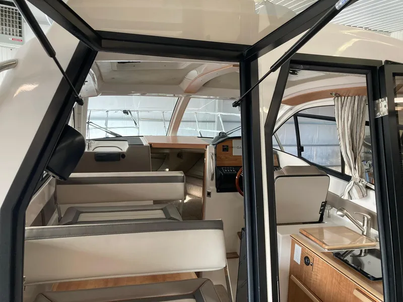 Slide: The Image of Interior of 2022 Cutwater C-24 Coupe boat, featuring seating and helm area. - 6