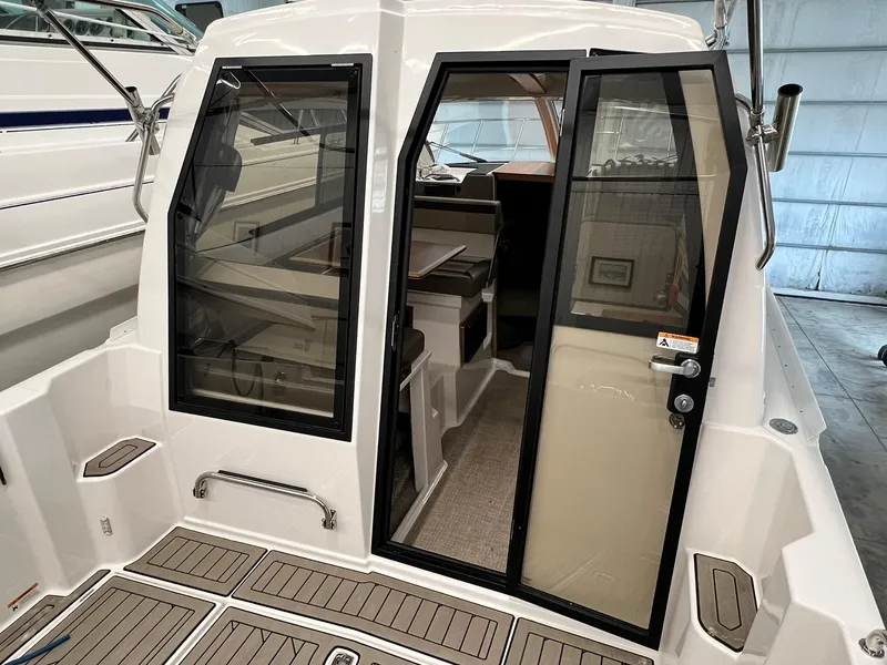 Slide: The Image of 2022 Cutwater C-24 Coupe boat interior with glass doors and teak flooring. - 7