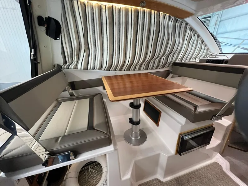 Slide: The Image of Interior of 2022 Cutwater C-24 Coupe with seating and wooden table. - 8